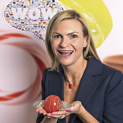 Jenn Ellek, Senior Director, Trade Marketing & Communications, National Confectioners Association holds candy glass art.