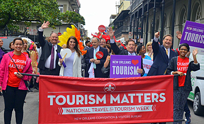 Stephen Perry, president and CEO of New Orleans Convention and Visitors Bureau, alongside Louisiana Lt. Governor Billy Nungesser announced the New Orleans' 2015 visitor numbers following a Mardi Gras-style parade through the French Quarter celebrating National Travel and Tourism Week. Photo by Jeff Anding.