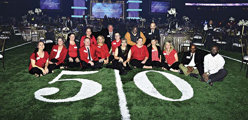 Aflac’s Heidi Carlisle (c) and her team on the 50-yard line at the Mercedes-Benz Superdome. Credits: Aflac