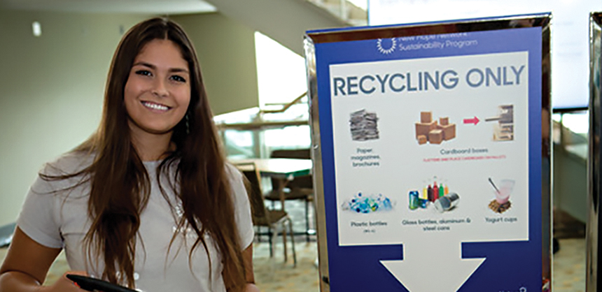 A volunteer at an event encourages attendees to recycle. Planners say some clients may be reluctant to change, so they suggest bringing clients along slowly to ease the transition. (Courtesy of Lindsay Arell)
