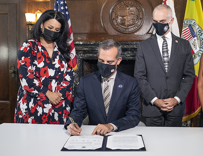 LA Mayor Eric Garcetti signs mandate.