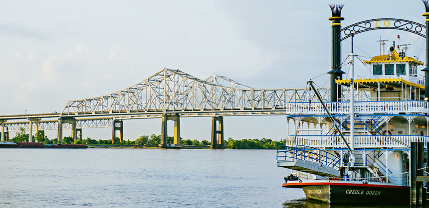 The Creole Queen steamboat, with the Mississippi River Bridge pictured in rear, is one of the many off-site activities offered in New Orleans. Photo by Justen Williams