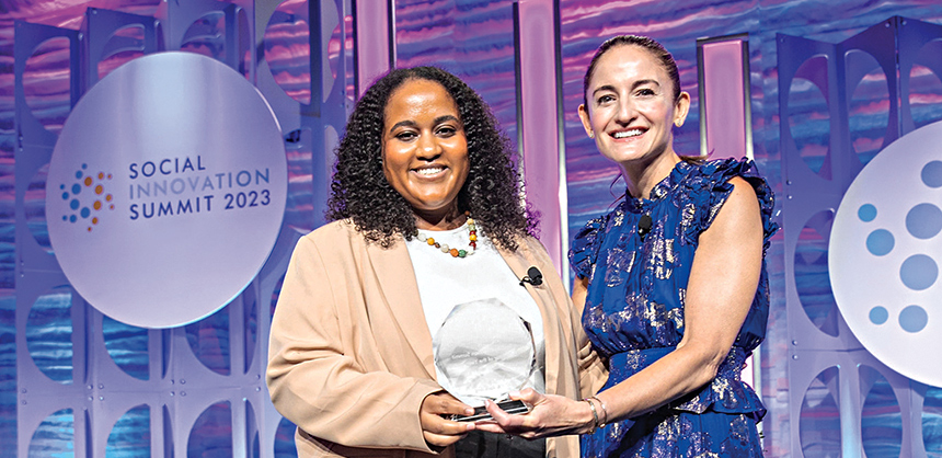 Olivia Brooks Allan, executive vice president of Landmark Ventures (R), hands the 2023 Social Innovation Summit Innovator of the Year award to Mitu Yilma, director of digital for the Born This Way Foundation at this year’s Social Innovation Summit. Rachael B. Photography