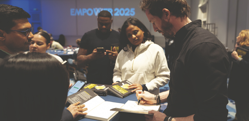 Sterling Hawkins autographed his book following his keynote speech about taking on challenges against all odds at EMPOWER 2025. Photo courtesy of Paragon Events