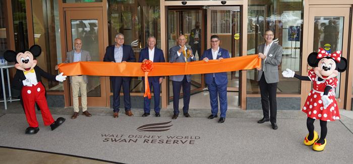 Pictured from left to right are: Mickey Mouse, Tishman Hotel and Realty Chairman and CEO John Vickers, MetLife Director of Hotel Asset Management Bill Webster, Marriott International President of US Eastern Region Jim Connelly, Principal Owner and Vice Chairman of Tishman Hotel and Realty Dan Tishman (with scissors), Walt Disney World Swan and Dolphin Resort Area General Manager Sean Verney, Walt Disney World President Jeff Vahle and Minnie Mouse