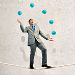 Businessman juggling with balls
