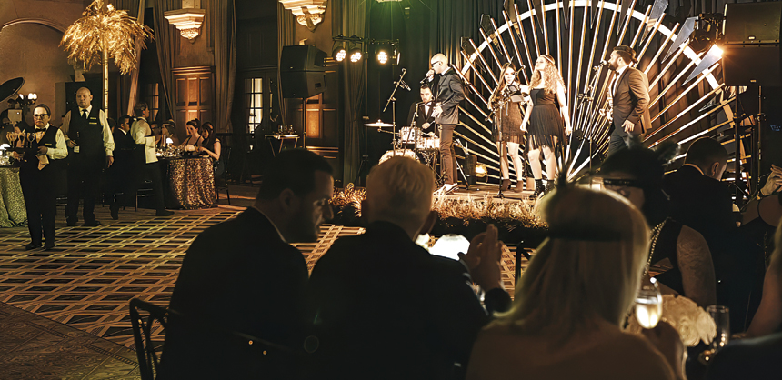 Attendees enjoyed a live band, dancing, a photo booth, caricature artists and a cigar station at this gilded Art Deco event. Photo courtesy of Chris Weinberg Events
